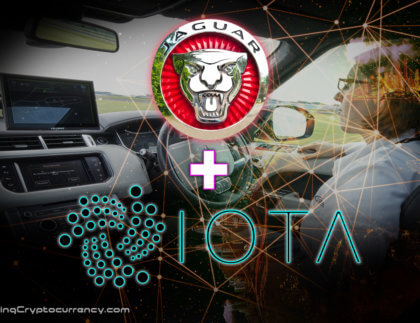 jaguar car logo and iota logo over inside land rover looking at dash with screen and driver with tech network overlay